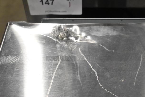 BRAND NEW Solwave SWA21T commercial microwave with scratch and dent on stainless steel surface; push button controls.