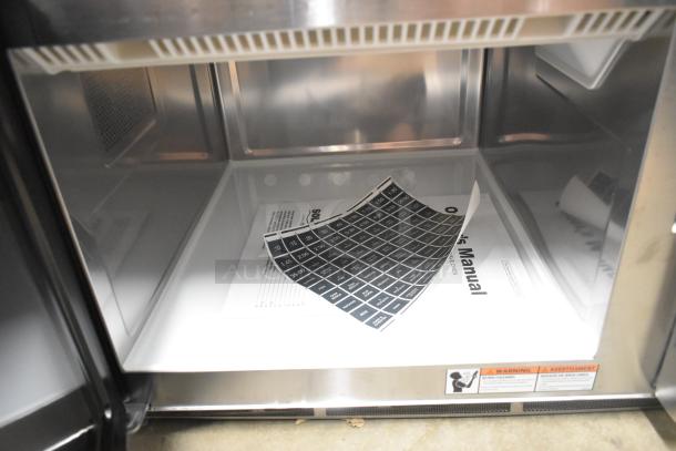 BRAND NEW Solwave SWA21T stainless steel commercial microwave interior showing push button controls and manual. 208/240V, 1 Phase.