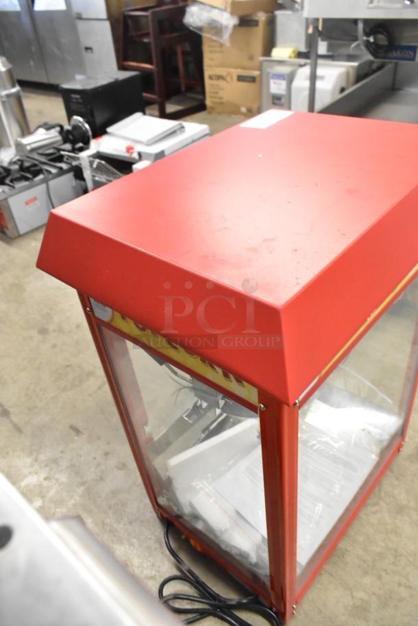 Brand new Carnival King 382PM30R 8 oz. red popcorn machine, commercial grade, 110V, visible light wear.