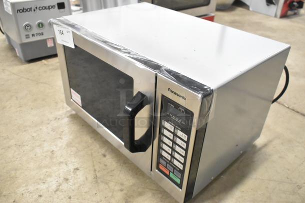 Brand new Panasonic NE-1054F stainless steel commercial microwave oven with keypad, 120V, 1 phase, minor scratches.