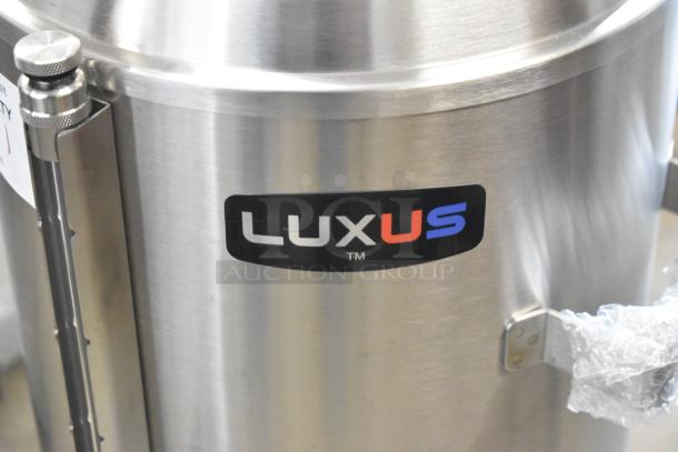 BRAND NEW Fetco TPD-30 Luxus 3 Gallon Coffee Dispenser, stainless steel, scratch and dent, "LUXUS" label visible.