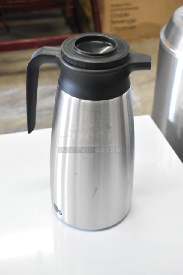 Stainless steel QINS SVP-1900A-N thermal pitcher, brand new with minor scratches and dents. Black handle and lid.