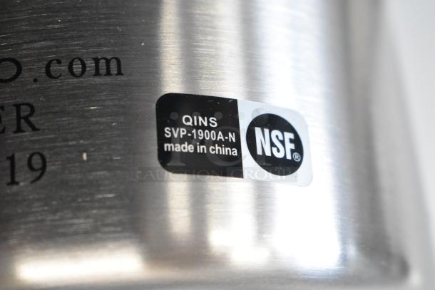 Stainless steel pitcher showing label with "QINS SVP-1900A-N," "made in China," and "NSF" certification. Brand new condition.