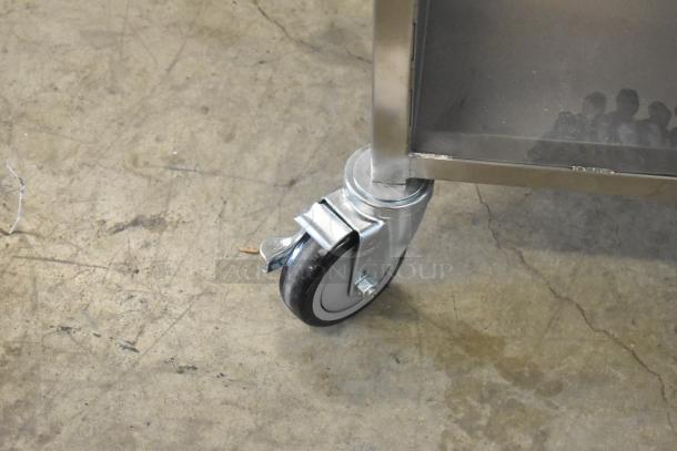 Brand new Avalon AFG34T-H heated donut glazer, 24"x34", stainless steel, with under shelf, on commercial casters.