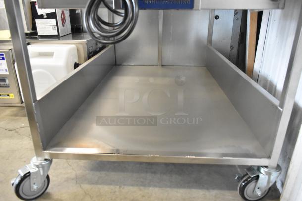 Brand new Avalon AFG34T-H 24" x 34" stainless steel heated donut glazer with undershelf and commercial casters. 120 volts, 1 phase.
