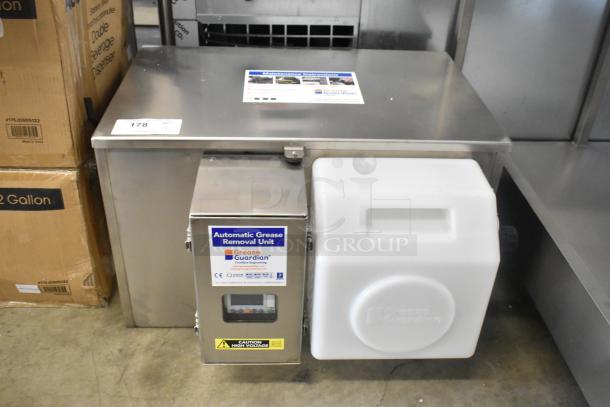 BRAND NEW FM Environment stainless steel 50 lb automatic grease removal unit with visible label and warning tag.