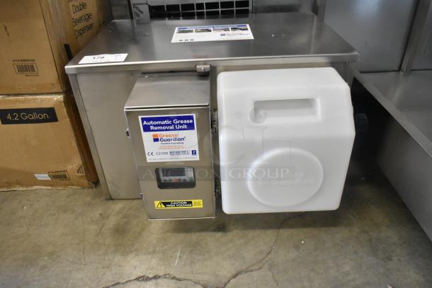 BRAND NEW FM Environment Stainless Steel 50 lb Automatic Grease Removal Unit. Visible "Grease Guardian" label, scratch and dent condition.