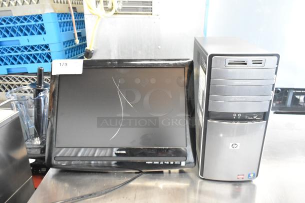 Toshiba monitor with visible scratches and HP Pavilion computer tower with front USB ports and expansion bays.