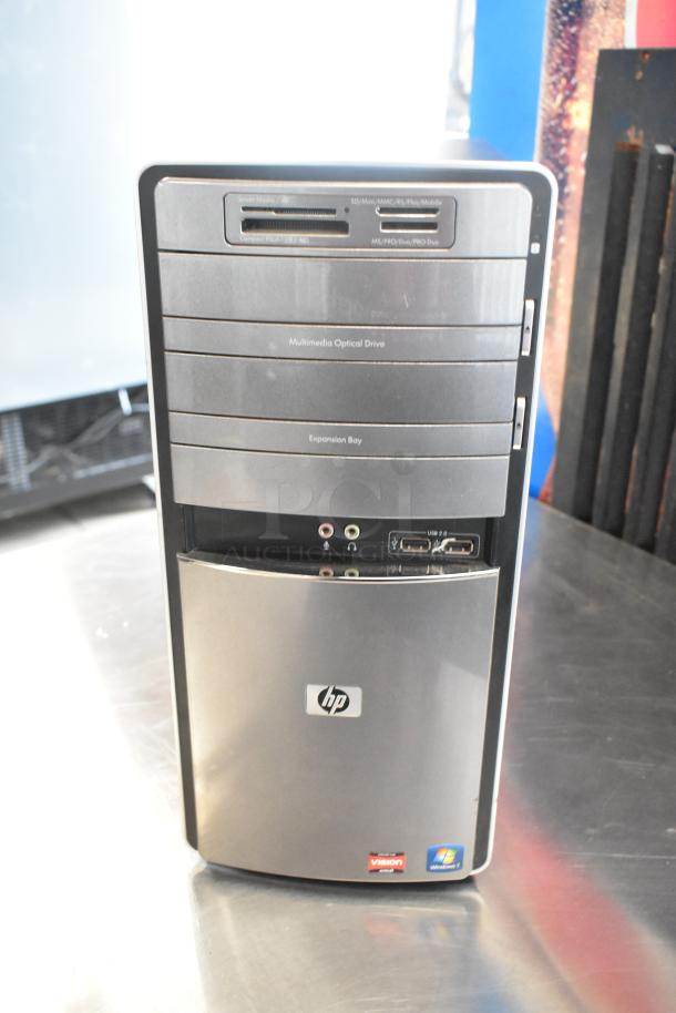 HP Pavilion computer tower with multimedia optical drive, expansion bay, USB ports, and Windows 7 sticker.