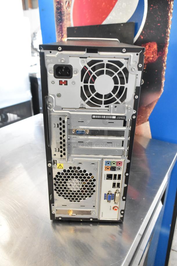 Back view of HP Pavilion computer tower showing various ports and ventilation fans. In good condition.