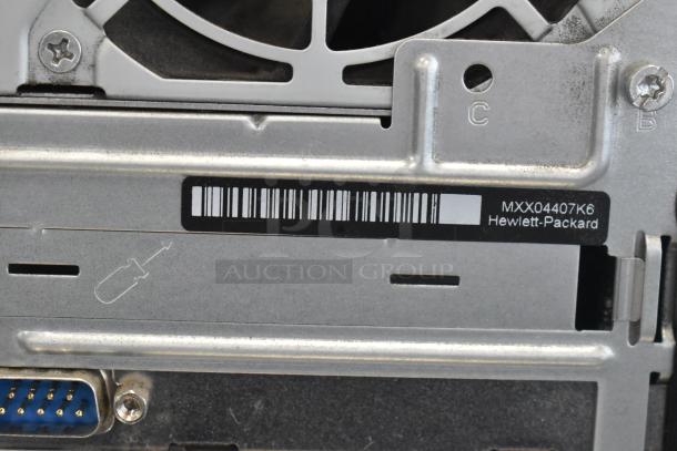 Toshiba monitor and HP Pavilion tower. Close-up shows model number MXX04407K6. Minor wear on back panel.