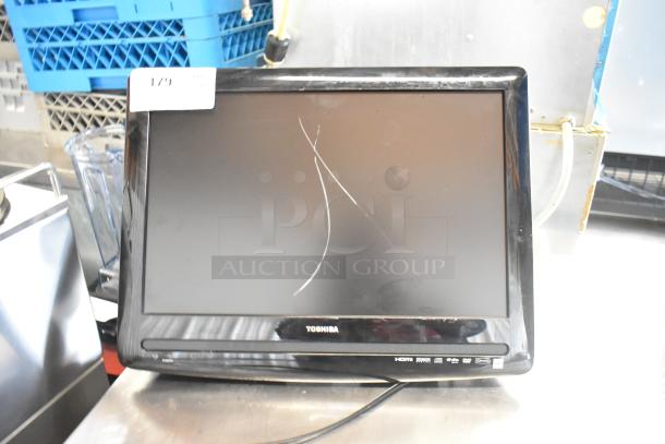 Toshiba Computer Monitor with visible screen scratches and sticker. Includes HDMI and power buttons at the bottom.
