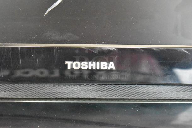 Toshiba computer monitor with visible logo, paired with HP Pavilion computer tower, minor surface wear on monitor.
