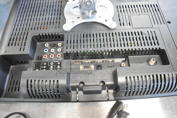 Back of a Toshiba computer monitor showing various input ports including HDMI, VGA, and audio connections.