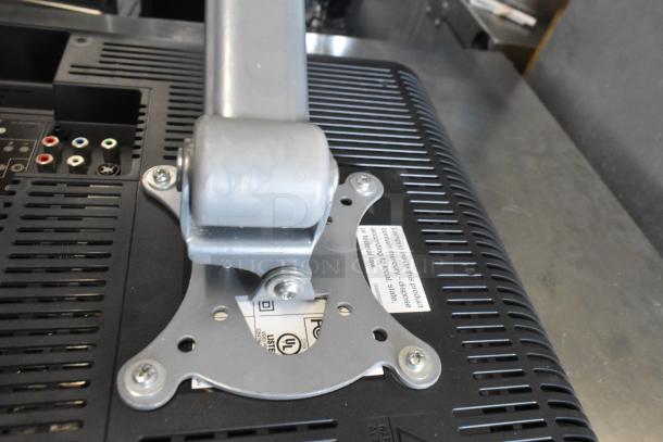 Toshiba computer monitor with mounting bracket and visible connection ports. Label indicates mercury disposal information.