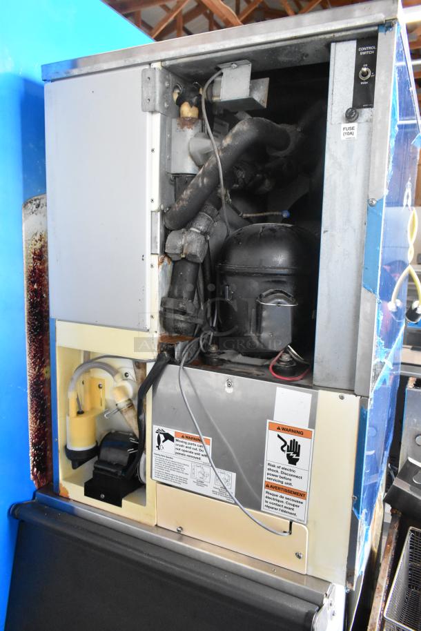 Hoshizaki KM-515MA stainless steel commercial ice head on bin, 115-120V, 1 phase, exposed internal components, warning labels visible.