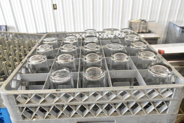 8 poly dish caddies with 19 beverage glasses, organized in a sturdy gray rack. Ideal for efficient storage and transport.