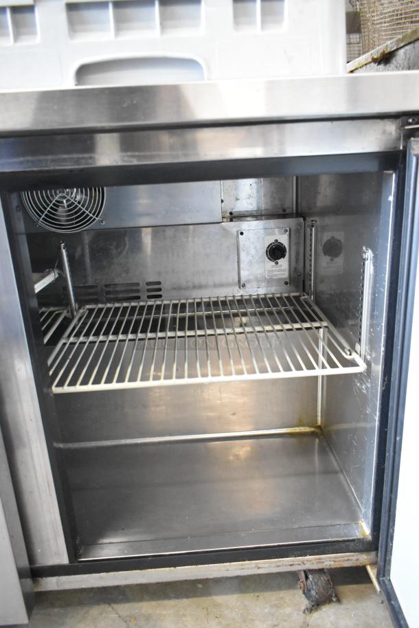 Turbo Air MUR-48 stainless steel commercial 2-door undercounter cooler, interior view. Features shelving, vent fan, on casters. 115V, 1 phase.