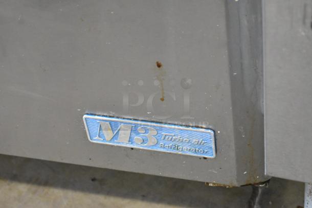 Turbo Air MST-72-30 label on a stainless steel commercial sandwich salad prep table with visible wear marks.