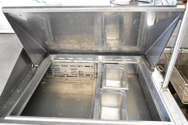 Turbo Air MST-72-30 stainless steel sandwich prep table, mega top with two-tier shelf, commercial casters shown.