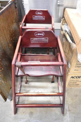 Pair of Winco wood high chairs with harness, wood pattern finish, durable design. Labels indicate inspection requirements.