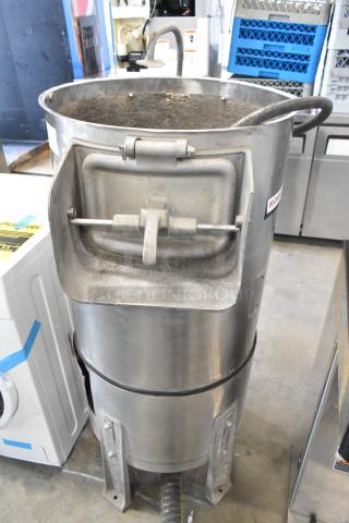 Hobart metal commercial floor-style potato peeler, showing wear. Features sturdy construction and identifiable Hobart logo.