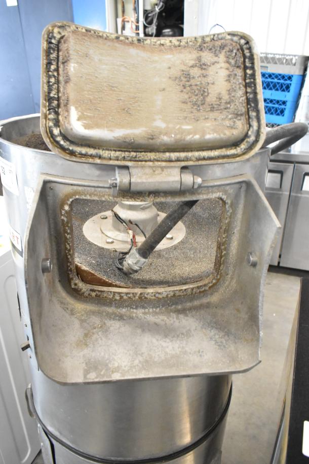 Hobart metal commercial floor-style potato peeler, showing wear and use, with visible internal components and manufacturer label.