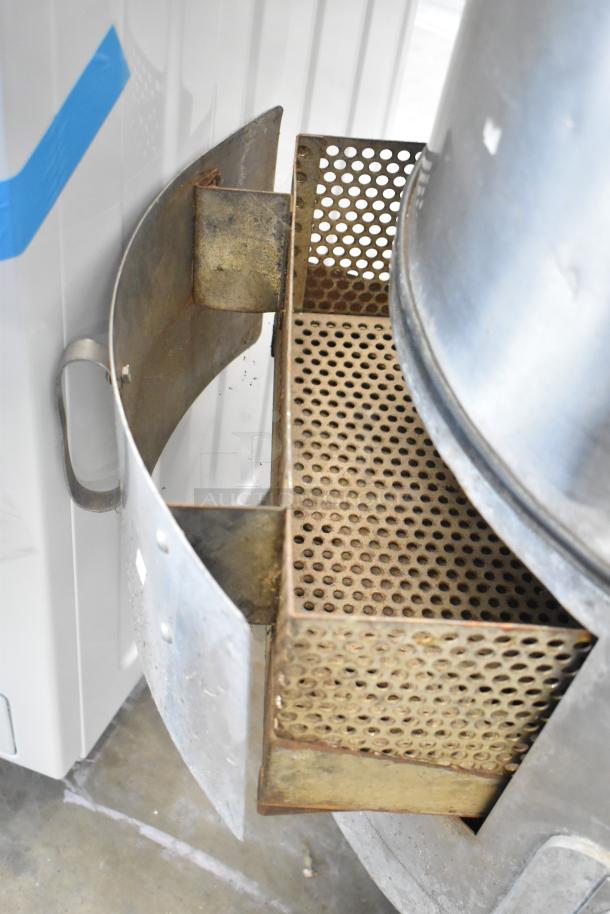 Hobart commercial metal floor-style potato peeler with perforated drum, showing signs of use, ideal for high-volume kitchens.
