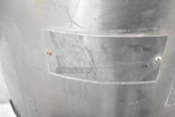 Hobart metal commercial floor-style potato peeler. Visible wear on surface, metal construction, industrial use.