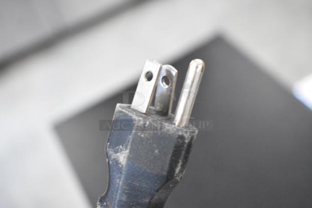 Close-up view of a three-prong electrical plug for a 2018 Bunn ICB-DV TALL iced tea machine, 120 volts, 1 phase.