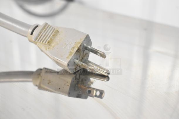 Close-up of a worn plug for the Ricemini RM-301DU rice washing machine, showing signs of rust and discoloration.