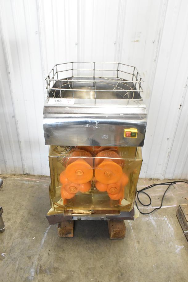 Stainless steel commercial countertop citrus juicer with cage, visible power switch; 115 volts, 1 phase.