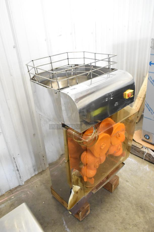 Stainless steel commercial countertop citrus juicer, 115 volts, 1 phase, with visible power switch and orange juicing components.