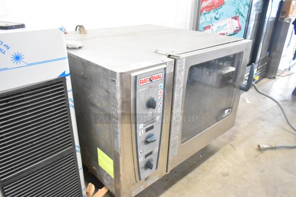 2016 Rational CMP 62G stainless steel commercial gas-powered combi convection oven on casters, visible control panel.