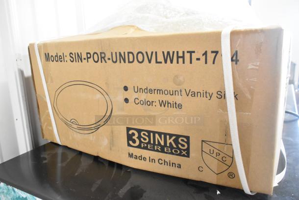 Boxed SIN-POR-UNDOVLWHT-1714 undermount vanity sink in white, labeled as new scratch and dent, three sinks per box.