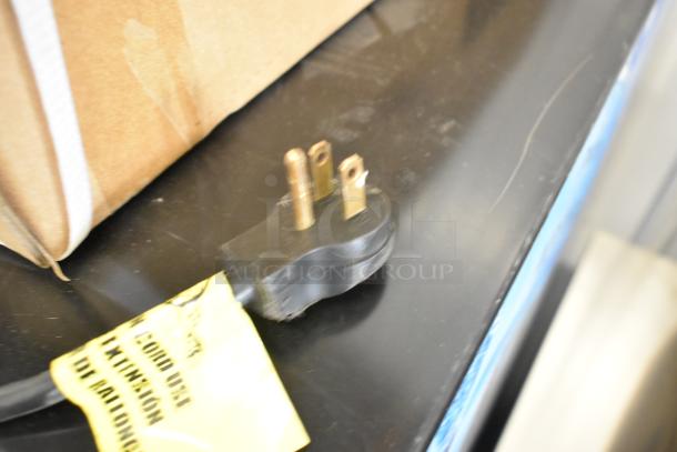 Power plug of Imbera VRD41 SD 48HC cooler, showing three-prong design. Yellow label advises against extension cord use.
