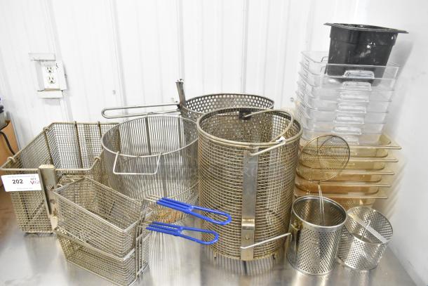 23 assorted kitchen items including metal fry baskets and poly bins, various sizes, used condition, auction lot 202.