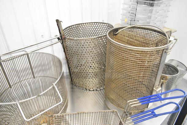 Assorted metal fry baskets and poly bins in mixed sizes; suitable for kitchen or industrial use. Good condition.
