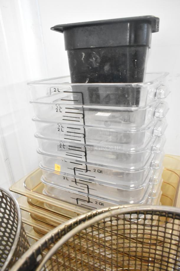 Stack of clear poly bins with measurement markings, alongside metal fry baskets. Auction includes 23 various items.