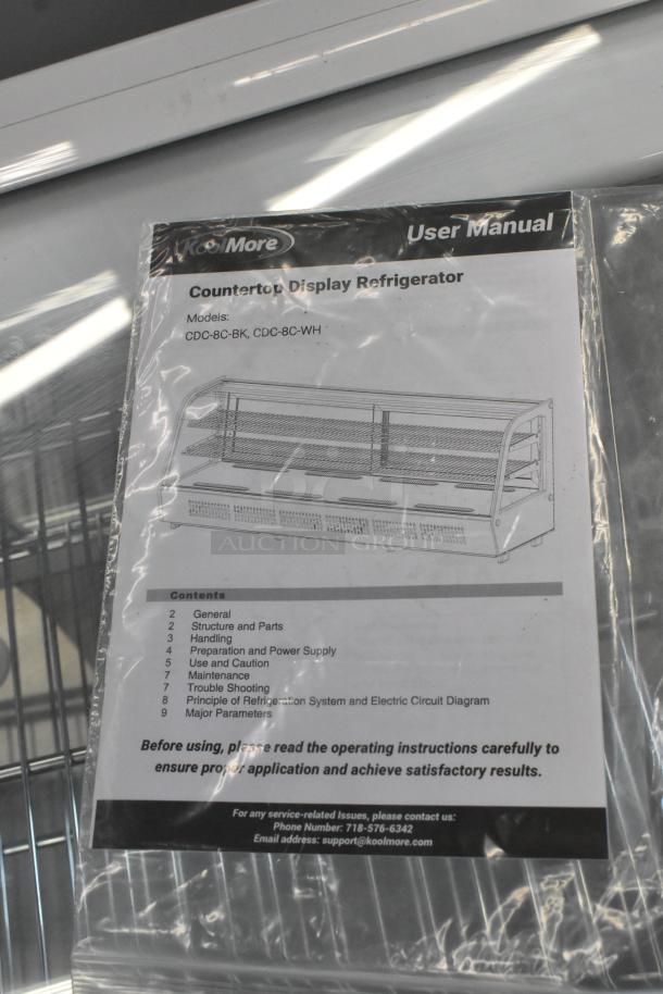 Brand new KoolMore CDC-8C-WH white countertop bakery display refrigerator, 8 cu. ft., 115 Volts. User manual shown.