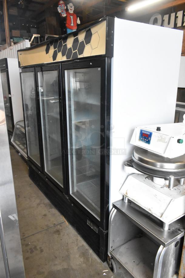 2018 Migali C-72FM commercial 3-door reach-in freezer with poly coated racks, black trim, in good condition.
