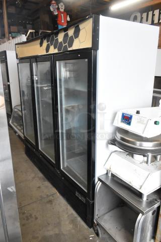 2018 Migali C-72FM commercial 3-door reach-in freezer with poly coated racks, black trim, in good condition.