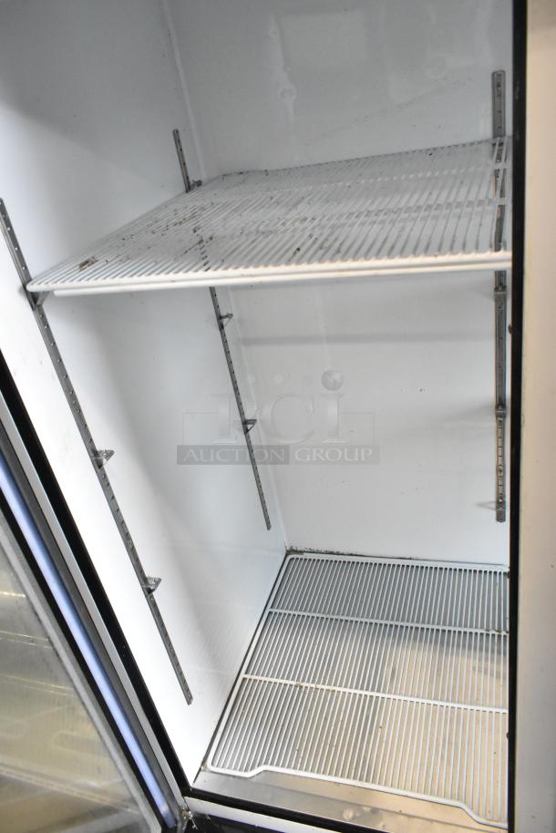 2018 Migali C-72FM Commercial 3-Door Freezer, poly coated racks, shown open, clean condition, 115/208-230 volts, 1 phase.