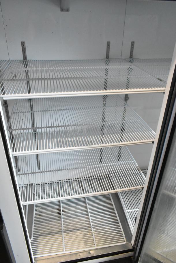 2018 Migali C-72FM 3-door commercial freezer with poly-coated racks, 115/208-230 volts, 1 phase, in excellent condition.