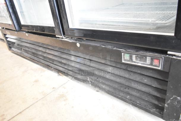2018 Migali C-72FM commercial 3-door freezer. Black exterior, poly-coated racks, 115/208-230V, 1 Phase. Visible controls.