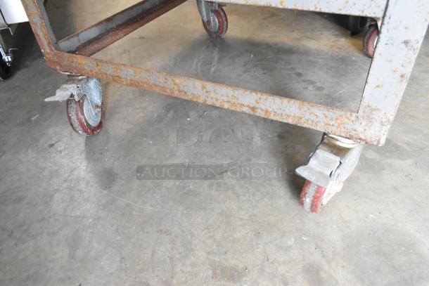 Stainless steel commercial rolled ice cream station on casters, showing signs of rust, 115 volts, 1 phase setup.