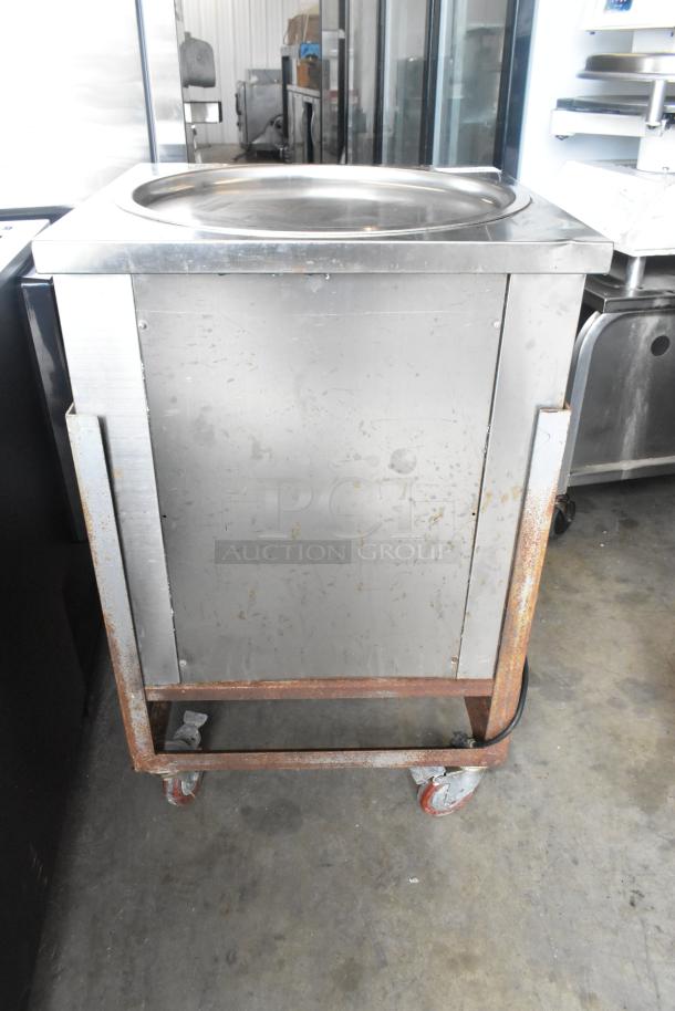 Stainless steel rolled ice cream station on commercial casters. 115 volts, 1 phase. Features a flat surface with visible wear.