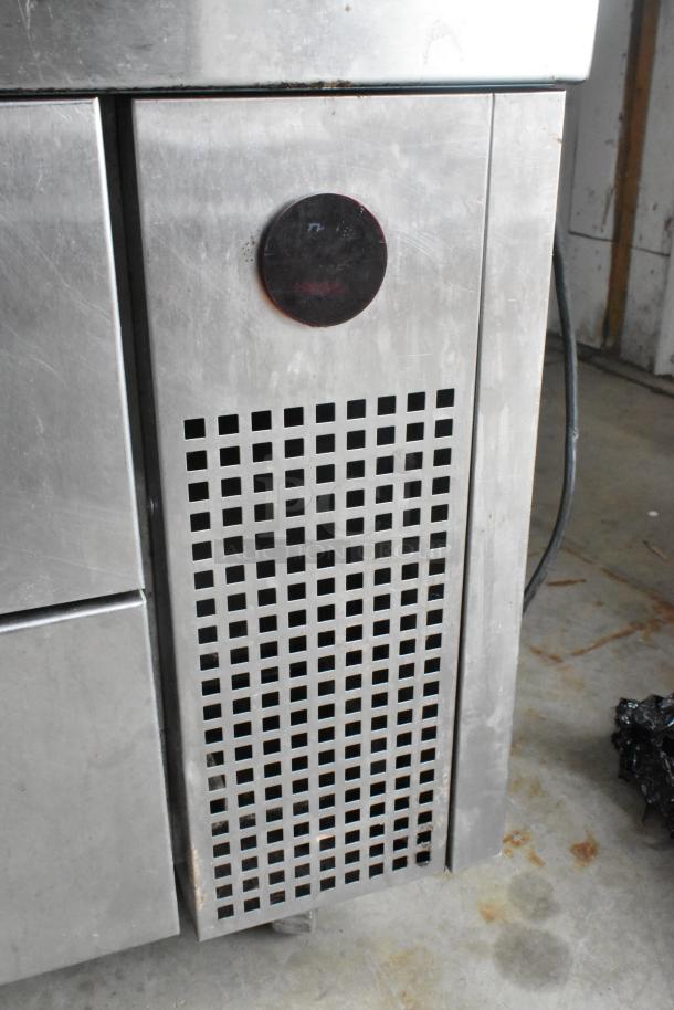 True TRCB-72 stainless steel 4-drawer chef base, commercial casters, 115 volts, shows moderate wear, ideal for kitchens.
