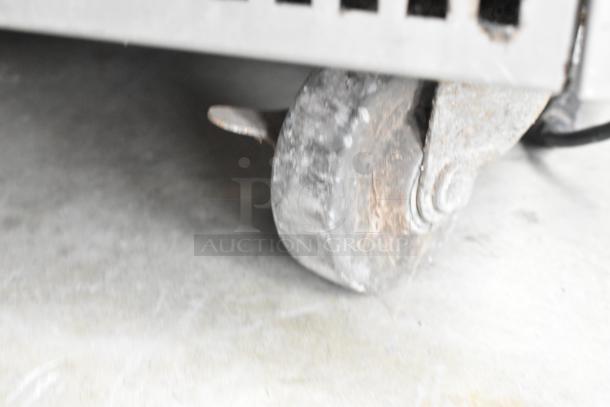 True TRCB-72 chef base caster, stainless steel, commercial use, 115 volts, 1 phase, visible wear on caster wheel.