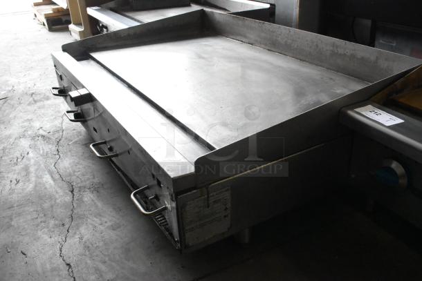 Vulcan 48RPG-E stainless steel countertop flat top griddle, natural gas powered, commercial use, visible control knobs.